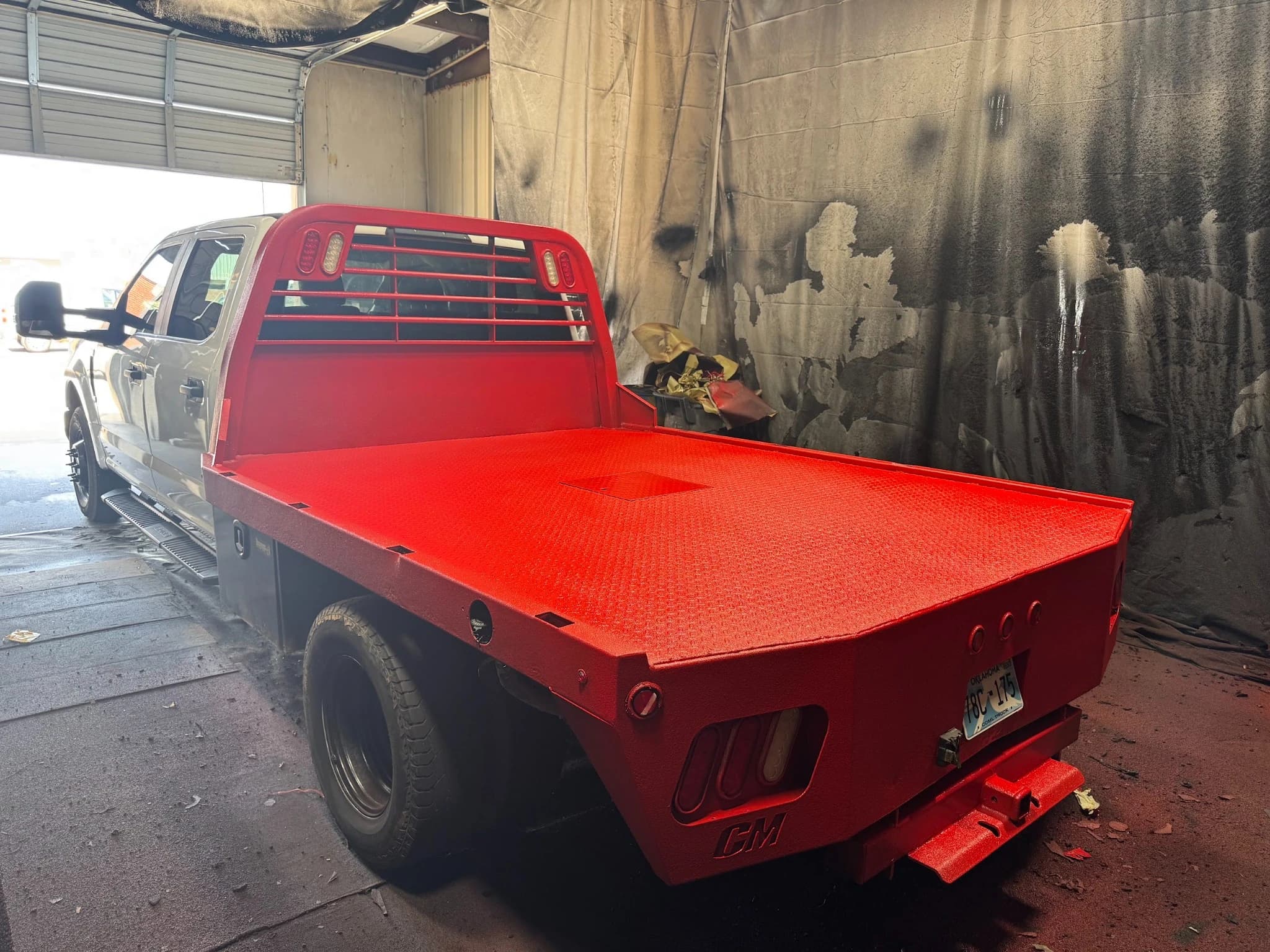 Red flatbed pickup in a workshop