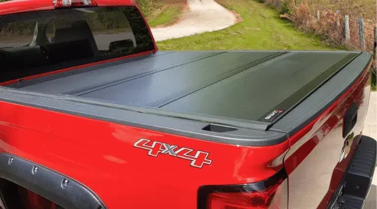 Low-profile hard folding truck bed cover on a pickup