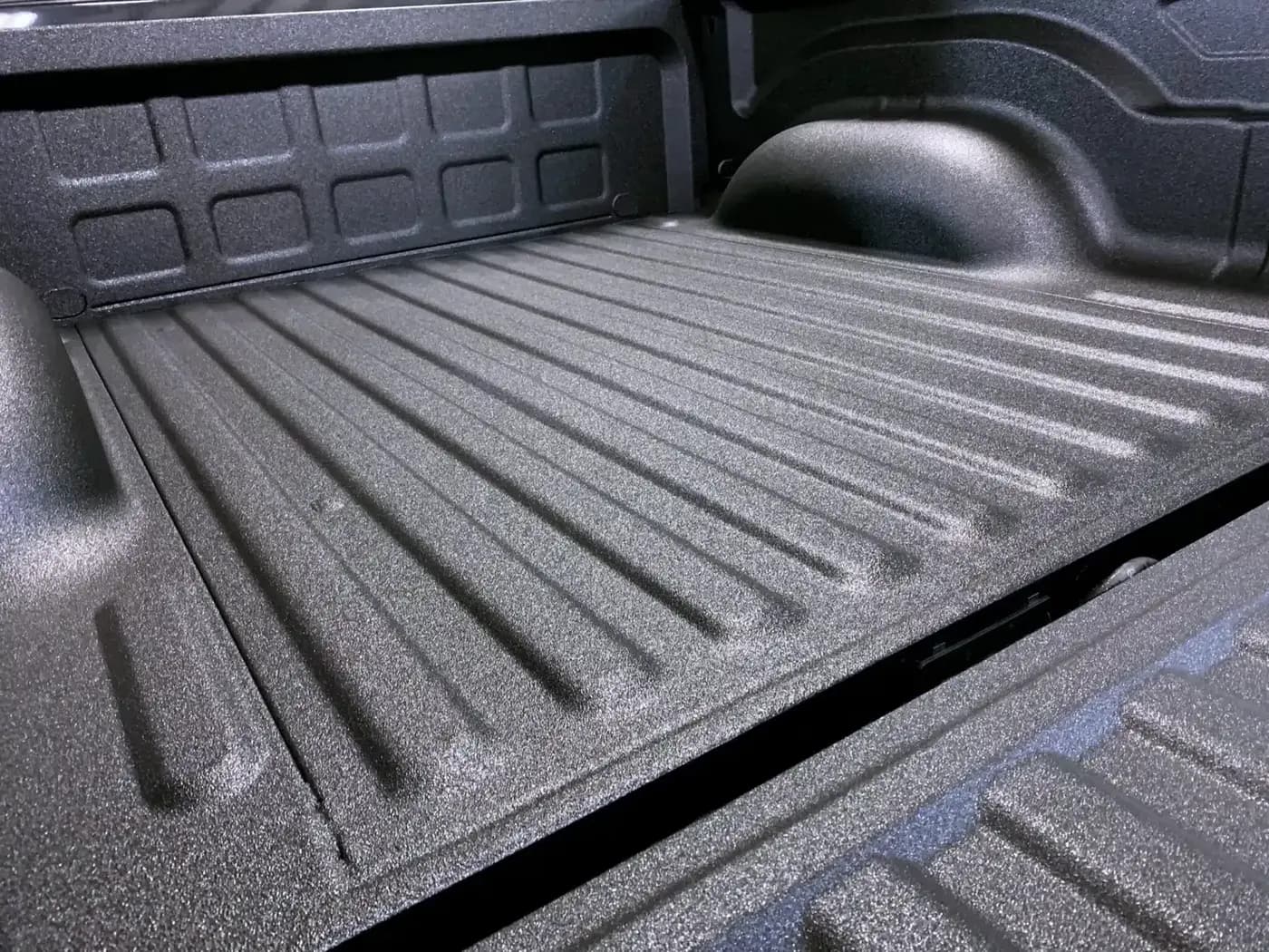 Durable spray-in liner protecting a pickup truck bed