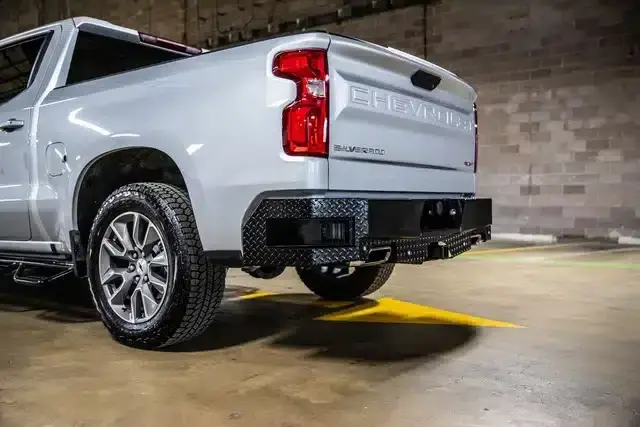 Aftermarket rear bumper installed on a silver Chevrolet truck
