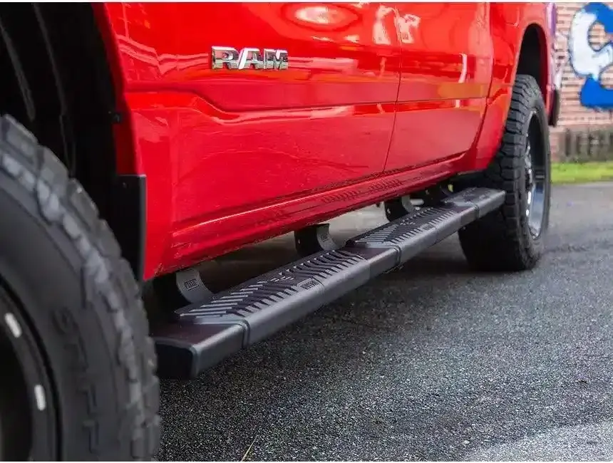 Black truck step bars mounted below a pickup cab